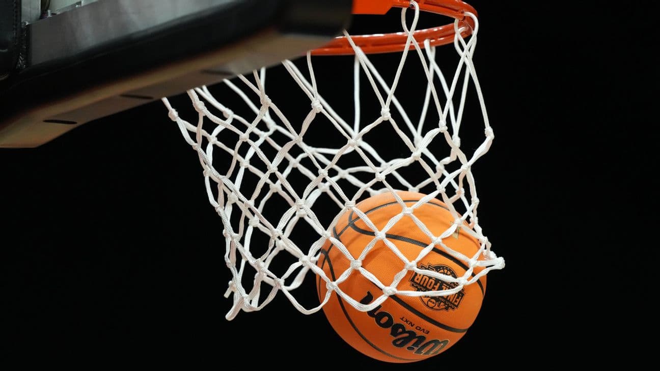 A basketball goes through a hoop.