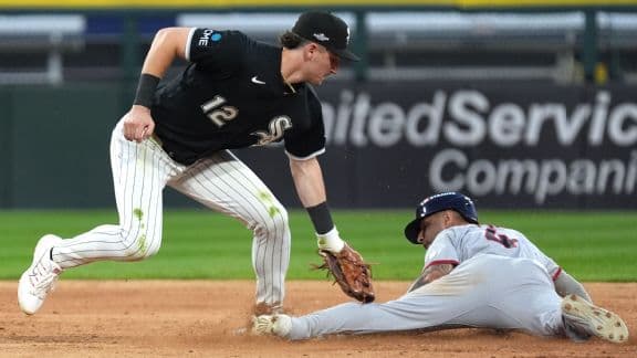 Cleveland Guardians shortstop Brayan Rocchio (4) steals second as Chicago White Sox shortstop Colson Montgomery (12) is late with the tag.