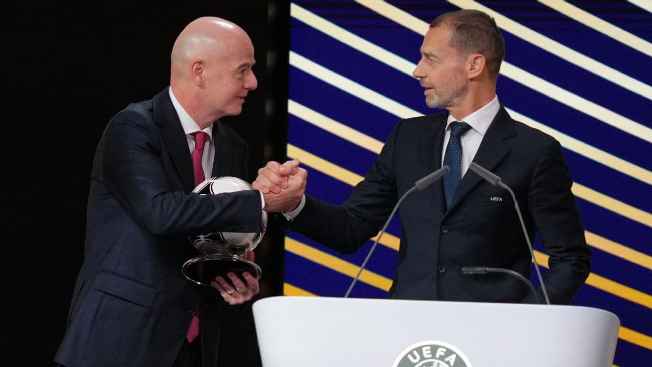 FIFA President Gianni Infantino (L) embraces UEFA president Aleksander Ceferin after addressing the 50th UEFA Ordinary Congress in Brussels on February 12, 2026