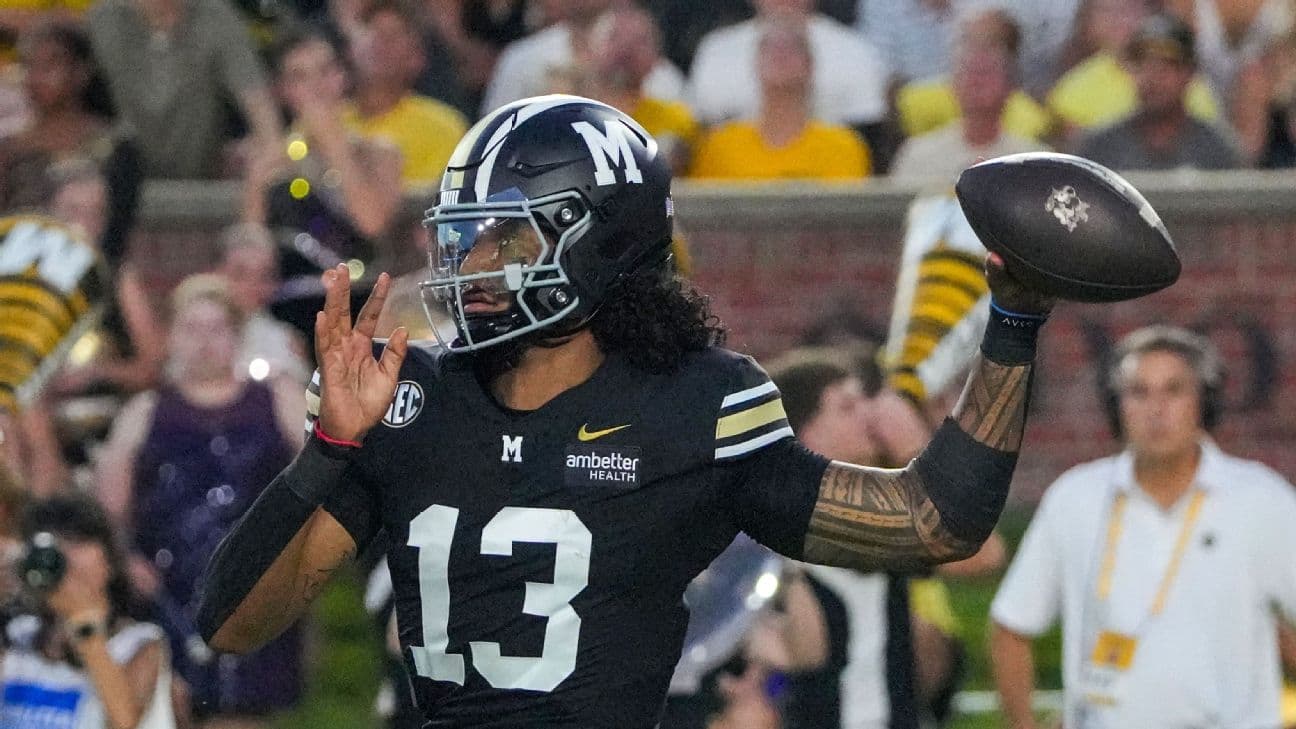 Missouri Tigers quarterback Austin Simmons (13) throws a pass against the Troy Trojans during the first half of the game at Faurot Field at Memorial Stadium.