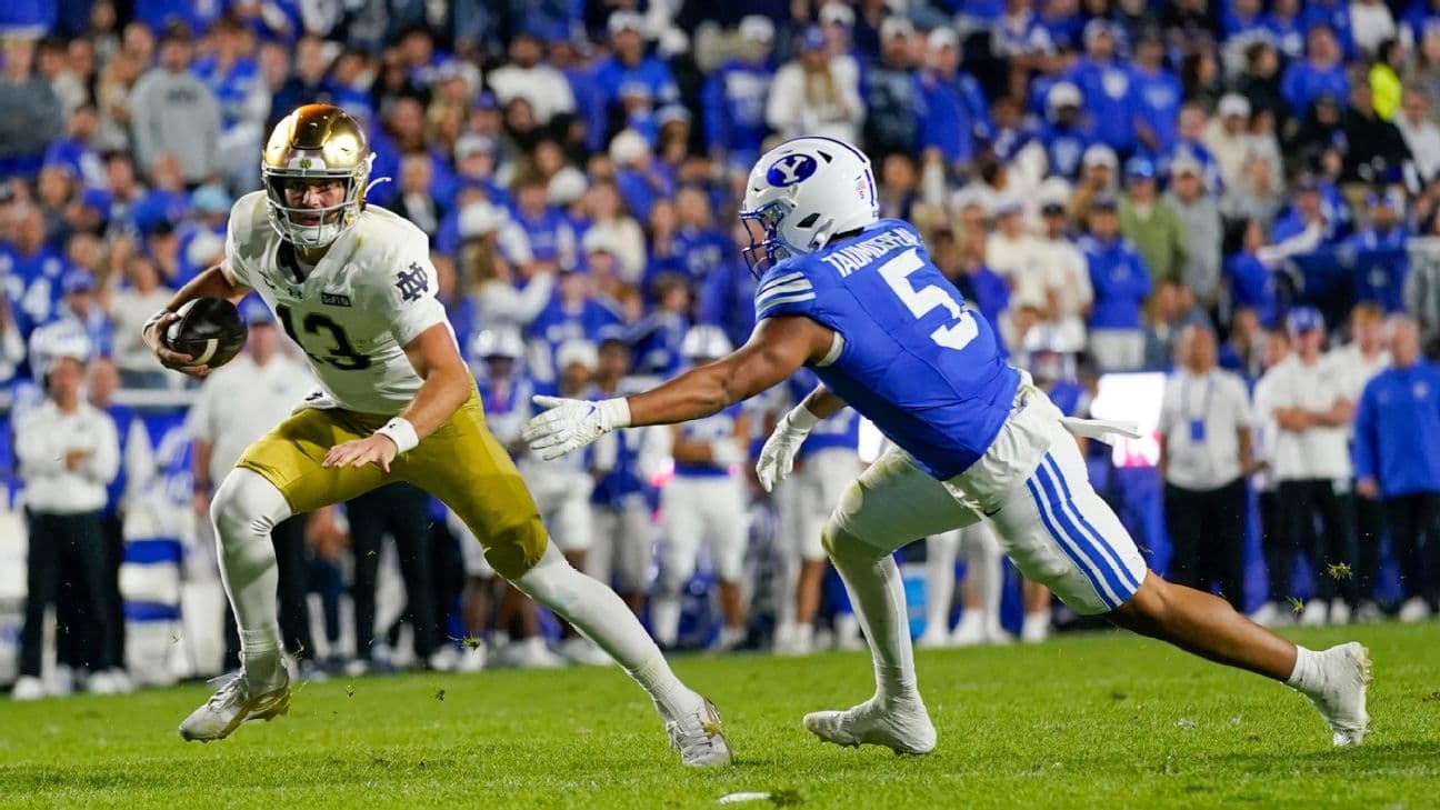 Notre Dame Fighting Irish quarterback CJ Carr (13) runs with the ball while being defended by BYU Cougars defensive end Nusi Taumoepeau (5) during a college football game between the Notre Dame Fighting Irish and the BYU Cougars on October 17, 2026 at LaV