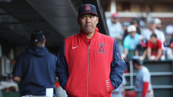 Manager Kurt Suzuki of the Los Angeles Angels looks on from the dugout.